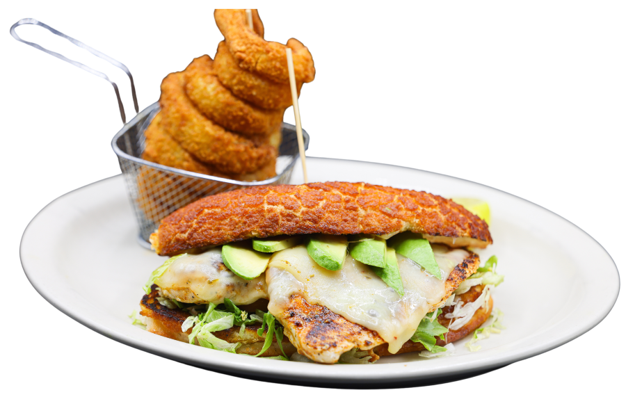 The philly chicken sandwich served with cheese and avocado on a french roll and served with onion rings